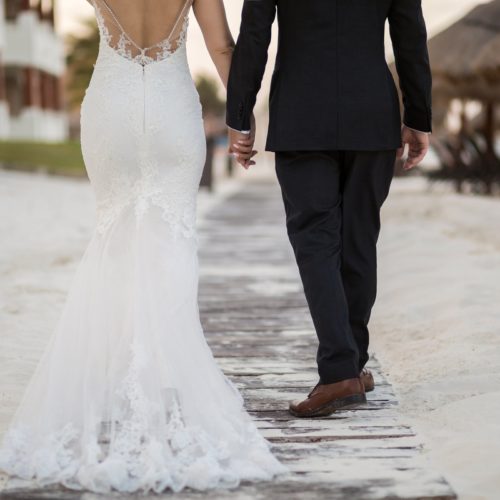 Close up of bride and groom walking away.