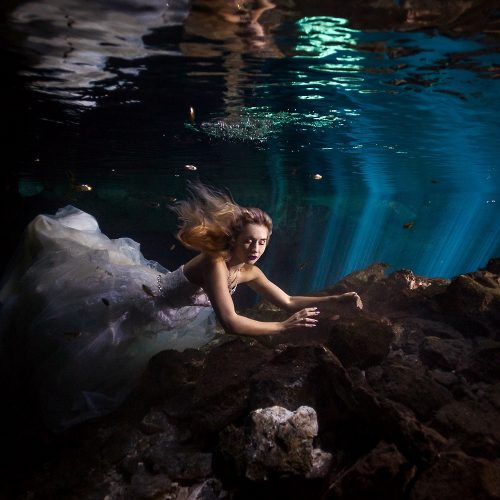 Bride in wedding dress underwater in Mayan Cenote Trash the Dress