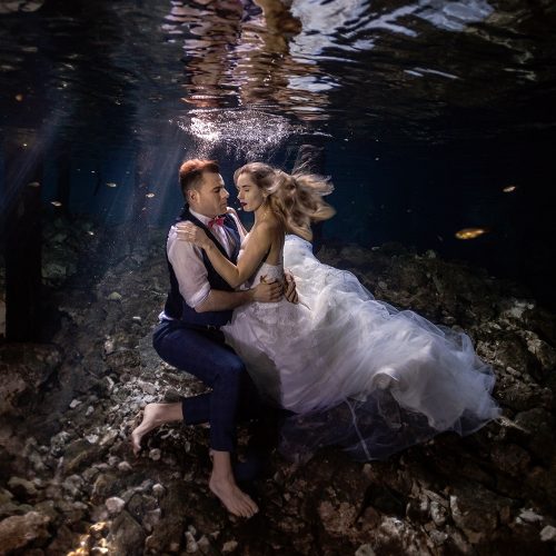 Bride and groom underwater in Mayan Cenote Trash the Dress