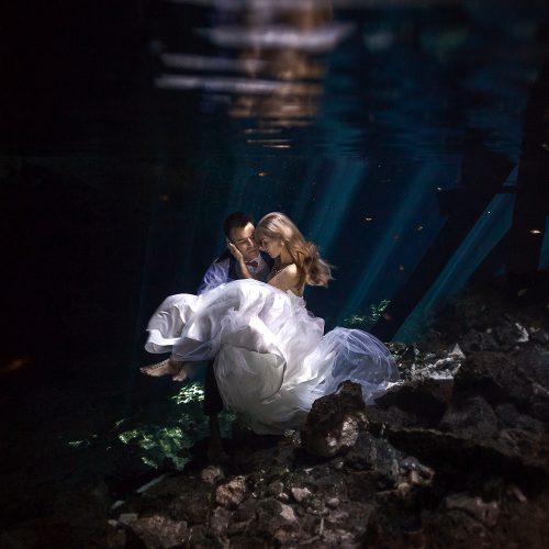 Bride and groom underwater in Mayan Cenote Trash the Dress