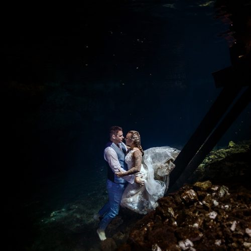 Bride and groom underwater in Mayan Cenote Trash the Dress