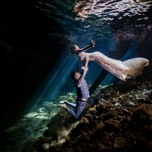 Bride and groom underwater in Mayan Cenote Trash the Dress