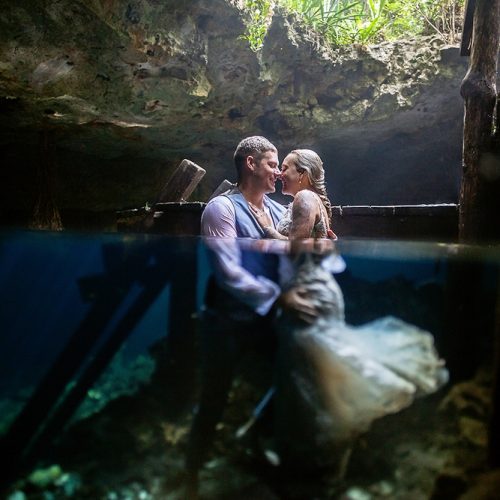 Bride and groom half underwater in Mayan Cenote Trash the Dress