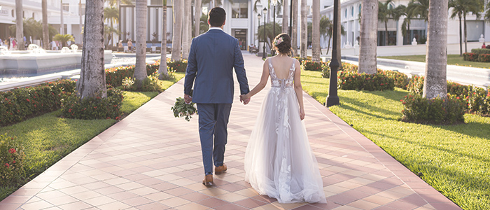 Couple walking to resort at wedding in Mexico