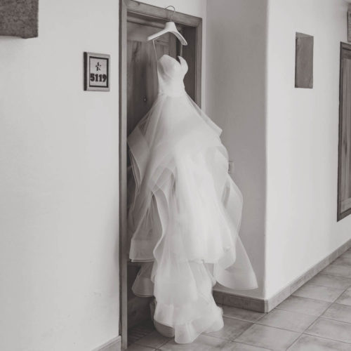 Wedding dress hanging on door at iberostar paraiso beach resort