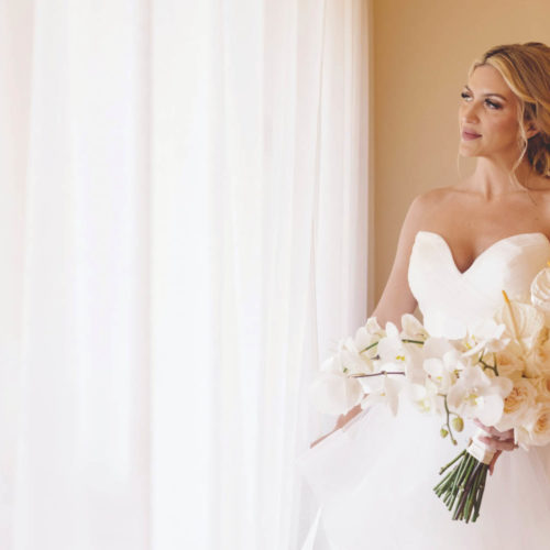Bride looking out window before wedding ceremony at iberostar paraiso beach resort