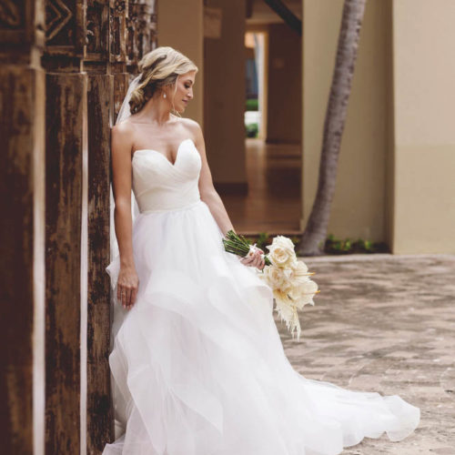 Creative portrait of bride leaning at iberostar paraiso beach resort