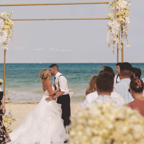 Bride and grooms first kiss at iberostar paraiso beach resort