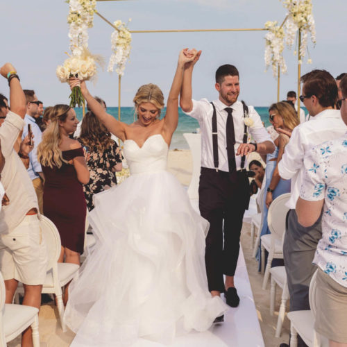 Bride and groom celebrate after wedding ceremony at iberostar paraiso beach resort