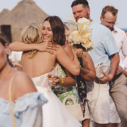 Bride emotionally hugging guests at iberostar paraiso beach resort