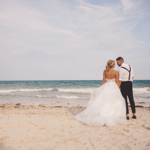 Bride leans into groom for creative portrait from behind at iberostar paraiso beach resort