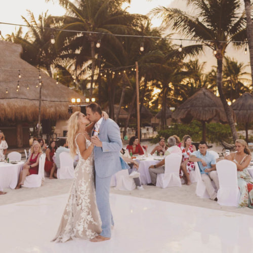 Bride and grooms first dance with sun behind them at Finest Playa Mujeres