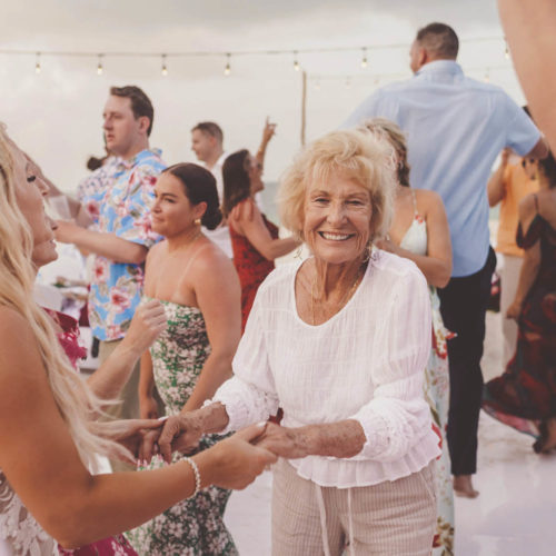 Grandma dancing on dance floor during beach reception at Finest Playa Mujeres