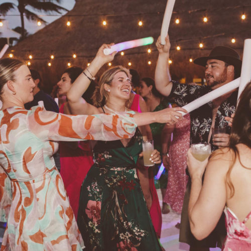 Guests dancing at wedding reception at night at Finest Playa Mujeres