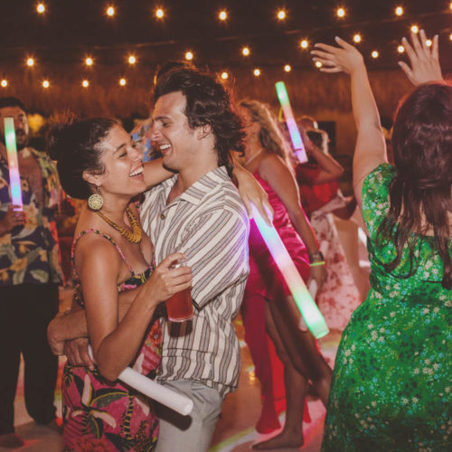 Guests laughing and dancing at wedding reception at Finest Playa Mujeres