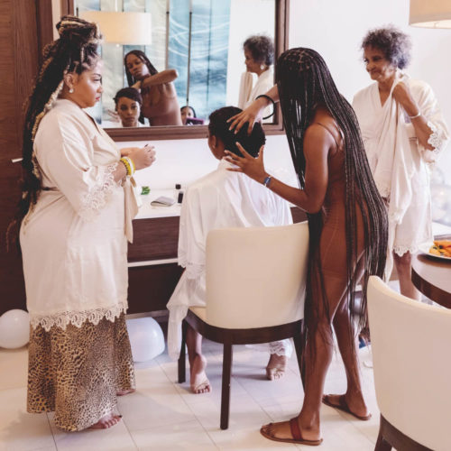 Bride getting ready in room with bridesmaids and family at Royalton Riviera Cancun Resort