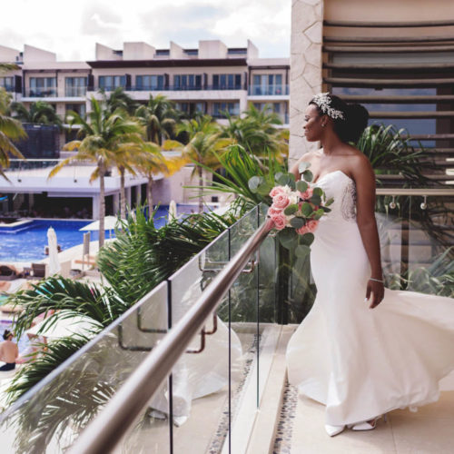 Lifestyle portrait of bride on balcony at Royalton Riviera Cancun Resort