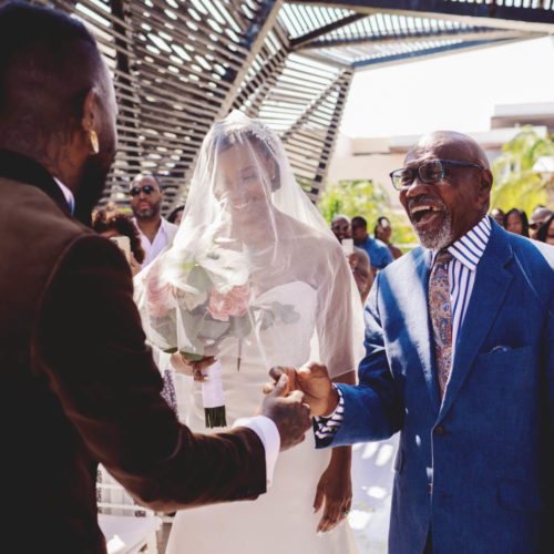 Father handing over bride to groom at wedding ceremony at Royalton Riviera Cancun Resort