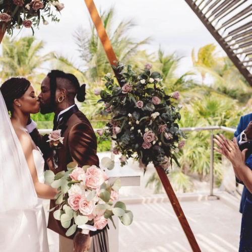 Morgan and Josh's first kiss at wedding ceremony at Royalton Riviera Cancun Resort