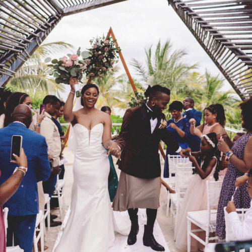 Morgan and Josh celebrate walking down the aisle after getting married at the gazebo Royalton Riviera Cancun Resort