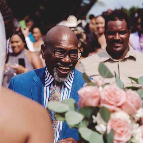 Father of the bride laughing shortly after wedding ceremony.