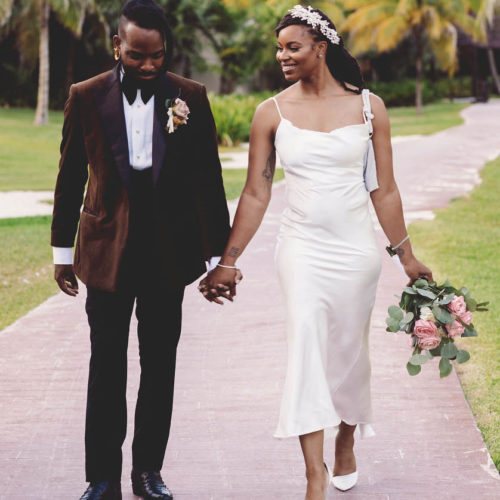 Morgan and Josh walking in wedding attire at Royalton Riviera Cancun Resort