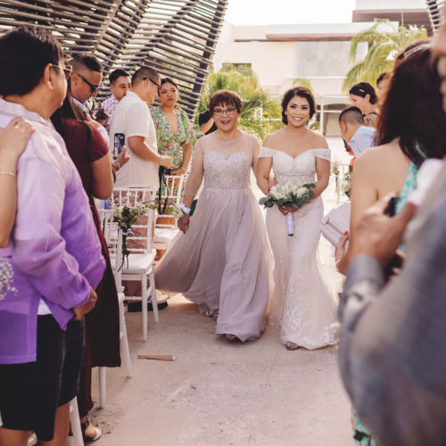 Bride walking down the aisle at the chapel at Royalton Riviera Cancun