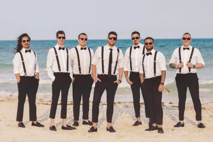 Groom and groomsmen at a wedding on the beach.