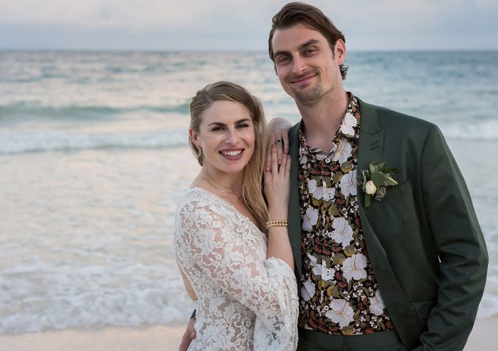 Bride and groom on beach with patterned shirt