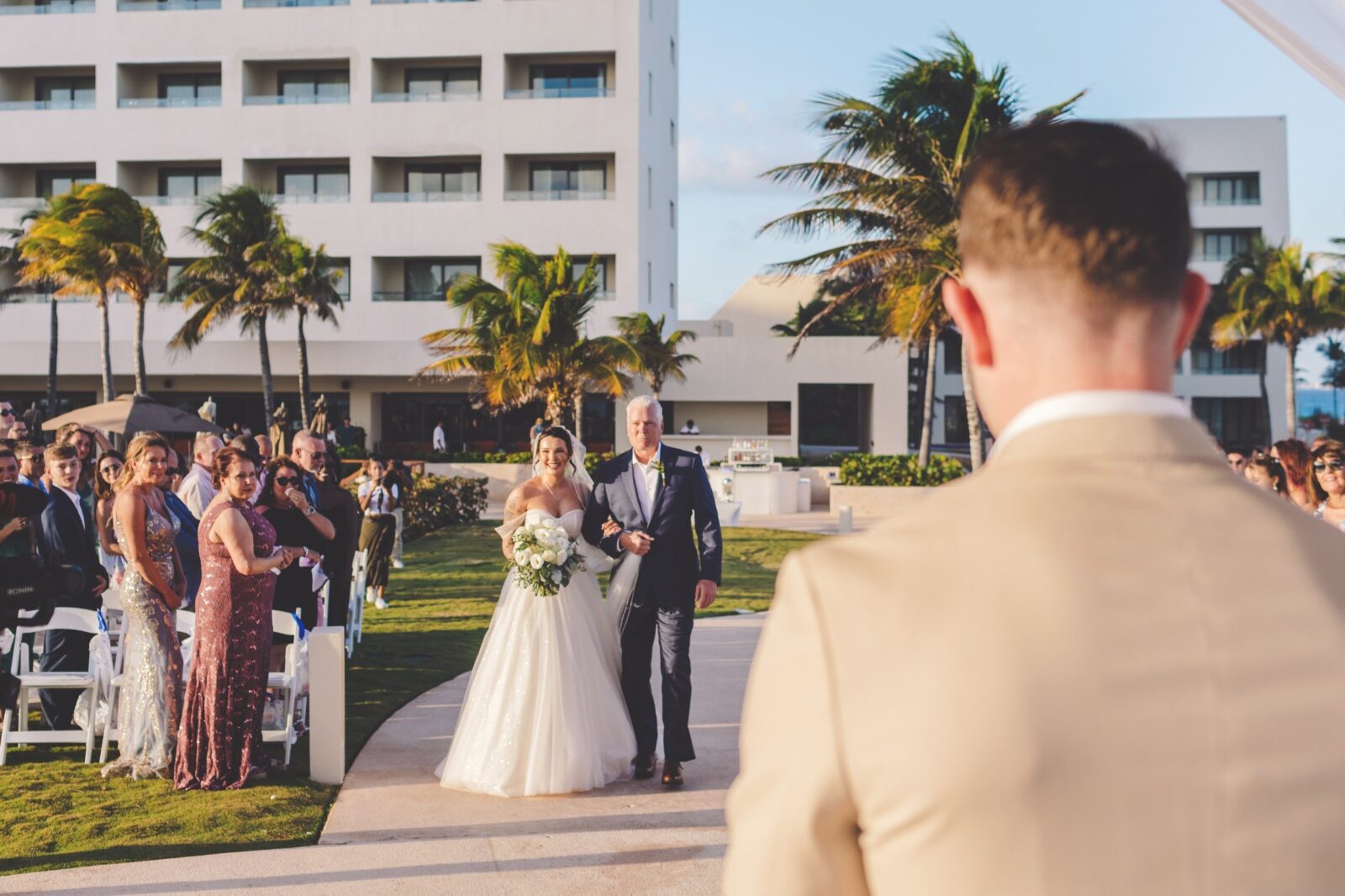 Bride walking down aisle at wedding in Cancun. 