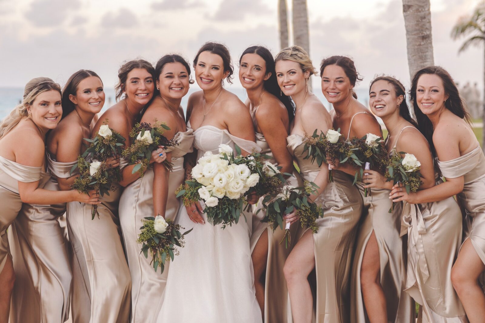 Bride and 9 bridesmaids looking amazing with fresh bridal beach makeup. 